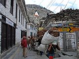 104 Marpha Busy Main Street Marphas main street is paved with slabs of stone covering an extensive drainage system. The flat-roofed houses are all neatly whitewashed along the busy narrow street, hectic with people, horses, and donkey trains.